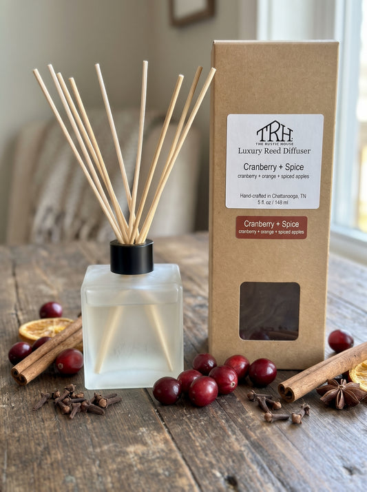 Cranberry + Spice reed diffuser in a styled lifestyle setting