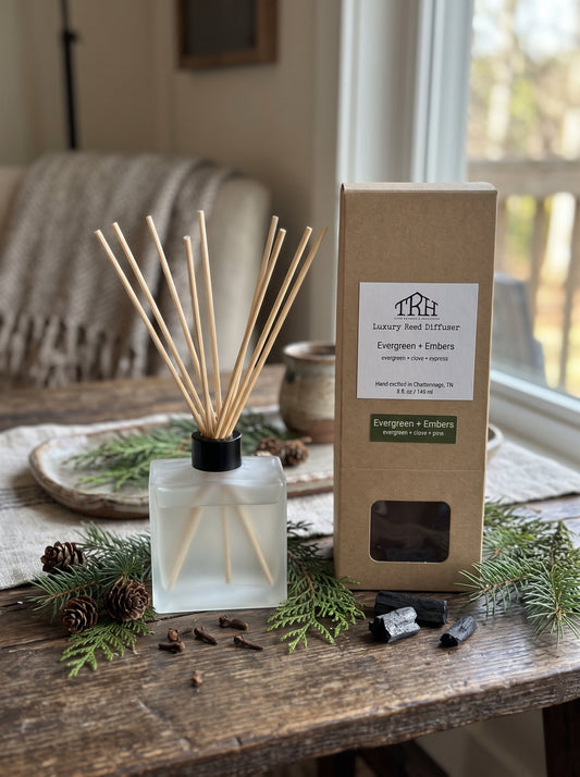 Evergreen + Embers reed diffuser in a styled lifestyle setting
