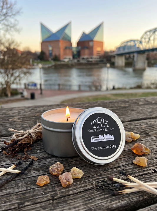 The Scenic City travel tin in a styled lifestyle setting